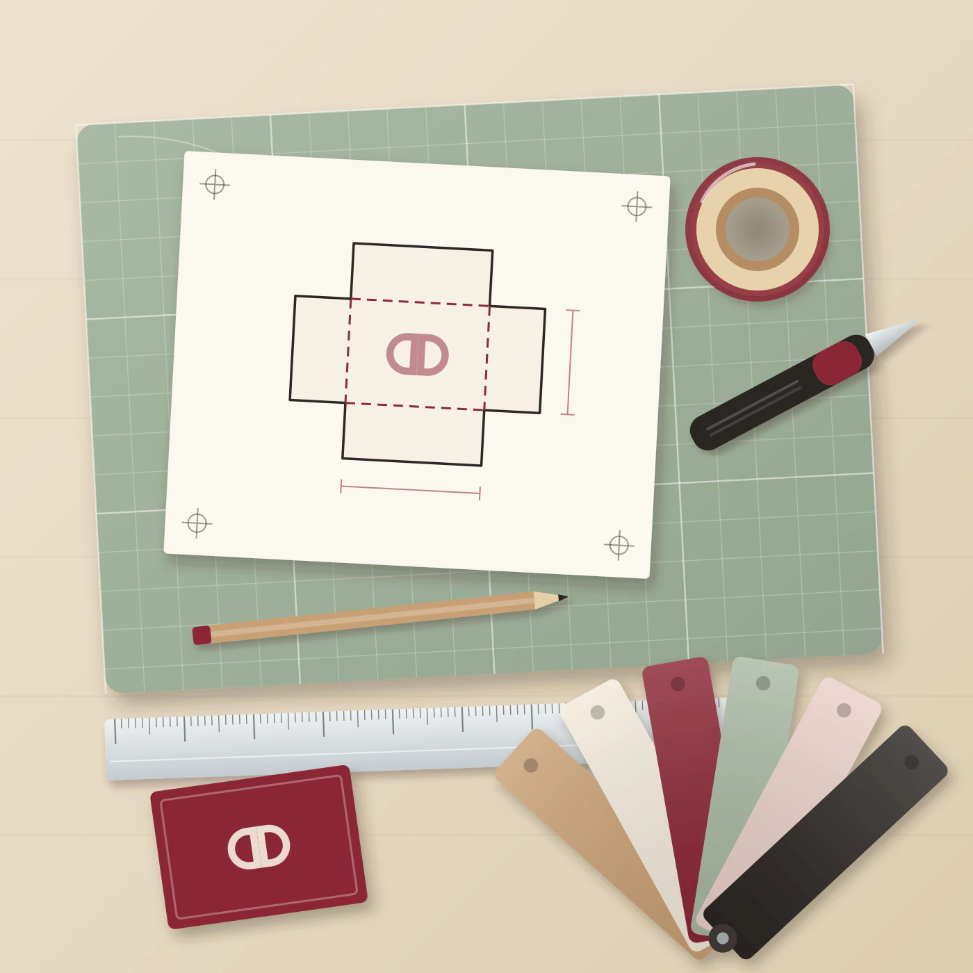 Flat-lay of a box dieline on a cutting mat with a ruler, knife, tape and swatch cards